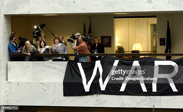 Protesters are removed from the 5th floor of the Hart Senate Office Building by U.S. Capitol Hill Police after they hung anti-war banners from the...