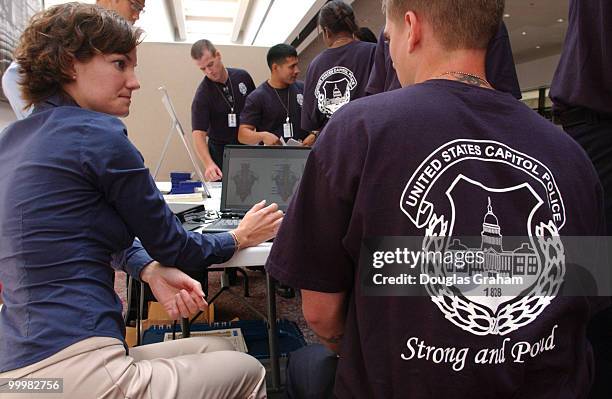 Carol Langenbach preforms a lumbar spine test on U.S. Capitol Police Officer Barry Kelly during a fitness/health day to kick off their new fitness...