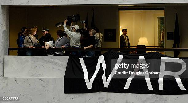 Protesters are removed from the 5th floor of the Hart Senate Office Building by U.S. Capitol Hill Police after they hung anti-war banners from the...