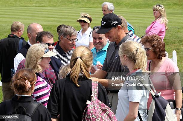 Ernie Els of South Africa signs autographs for fans during the Pro-Am round prior to the BMW PGA Championship on the West Course at Wentworth on May...