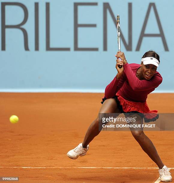 Venus Williams returns the ball to Italian Francesca Schiavone during their match of the Madrid Masters on May 12, 2010 at the Caja Magic sports...