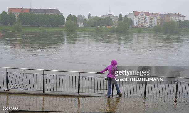 Woman holds on to the railing as she walks in the flood water at the banks of the River Oder in the eastern German city of Frankfurt/Oder on the...