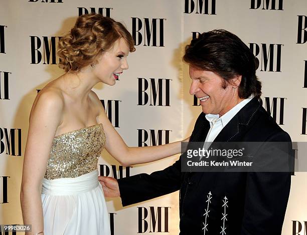 Singer/songwriters Taylor Swift and John Fogerty arrive at the 58th Annual BMI Pop Awards at the Beverly Wilshire Hotel on May 18, 2010 in Beverly...