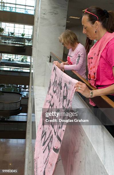 Protesters staged an anti-war rally in the Hart Senate Office Building hanging banners, setting up a mock-graveyard and reading the names of the war...
