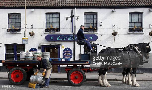 Head horseman Barry Petherick and horseman Martin Whittle stop to deliver beer to a local pub using Shire Horses Max and Monty on May 19, 2010 in...