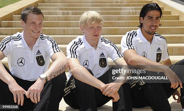 Germany's midfielder Marcell Jansen, Germany's defender Andreas Beck, and Germany's midfielder Sami Khedira pose for photographers after speaking to...