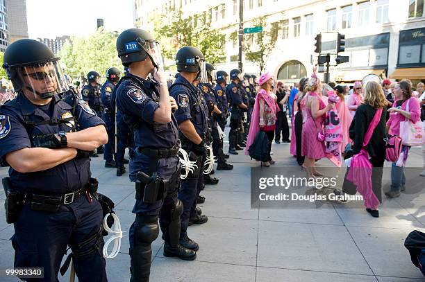 Code Pink protesters confront police in riot gear during a anti-war protest on St. Paul Street near the Xcel Center in St. Paul, Minn., during the...
