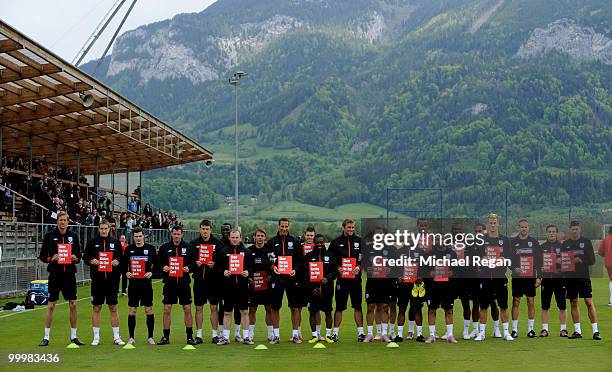 The England squad pose with anti-racism cards during an England training session on May 19, 2010 in Irdning, Austria.