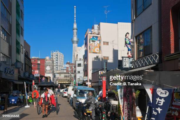 rickshaw and tokyo skytree in the old downtown asakusa district of tokyo, japan - shitamachi stock pictures, royalty-free photos & images
