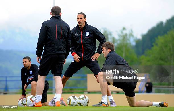 Rio Ferdinand talks to Michael Carrick and Wayne Rooney during an England training session on May 19, 2010 in Irdning, Austria.
