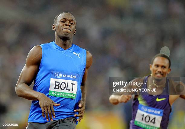 World and Olympic triple gold medallist Usain Bolt from Jamaica crosses the finish line ahead of Michael Frater from Jamaica during the men's 100...