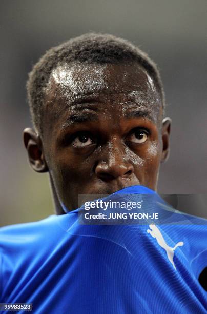 World and Olympic triple gold medallist Usain Bolt from Jamaica checks the electric board after the men's 100 meter event of the Daegu...