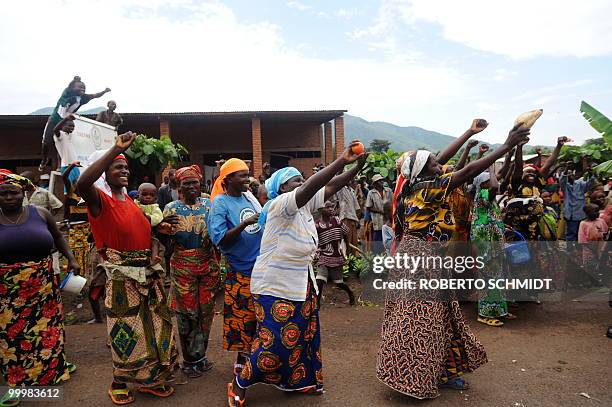 Supporters of Burundian President Pierre Nkurunziza crowd the side of a road as they wave to him near the town of Rugombo in northern Burundi on May...