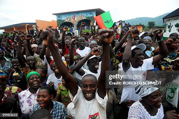 Supporters of Burundian President Pierre Nkurunziza cheer him on as he heads to a political party in Rugombo in northern Burundi on May 14, 2010. The...