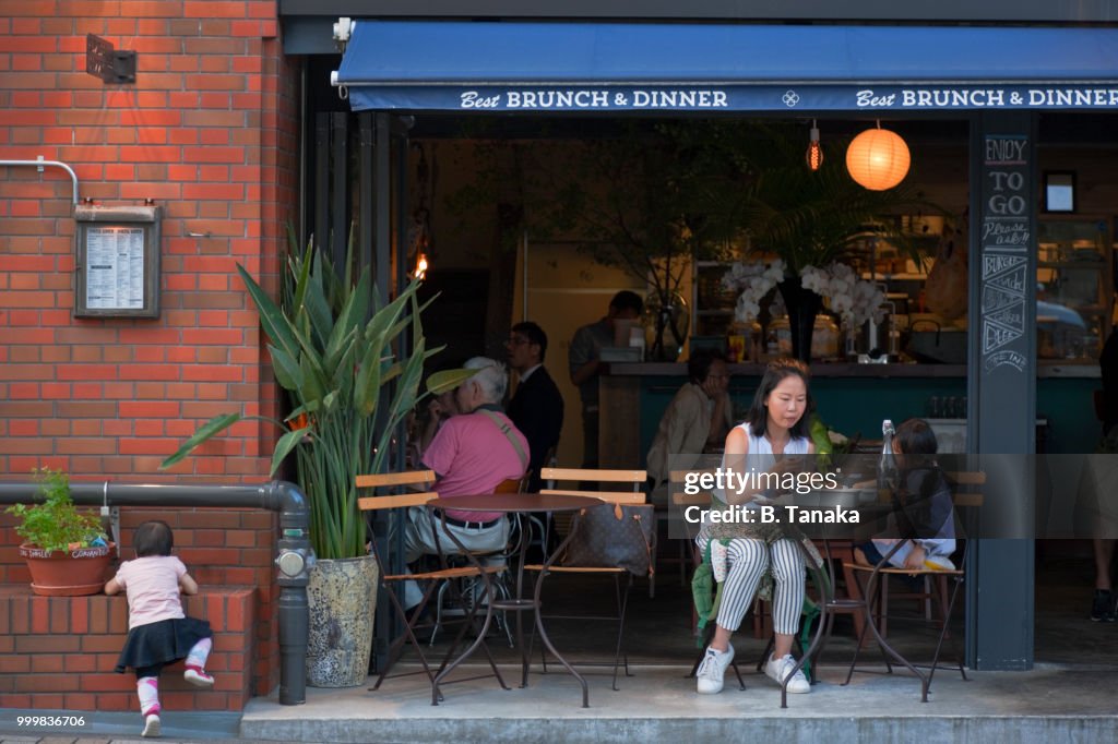 Young Family at Café Terrace in the Old Downtown Asakusa District of Tokyo, Japan