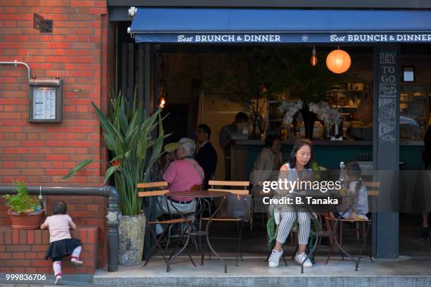young family at café terrace in the old downtown asakusa district of tokyo, japan - tanaka stock pictures, royalty-free photos & images