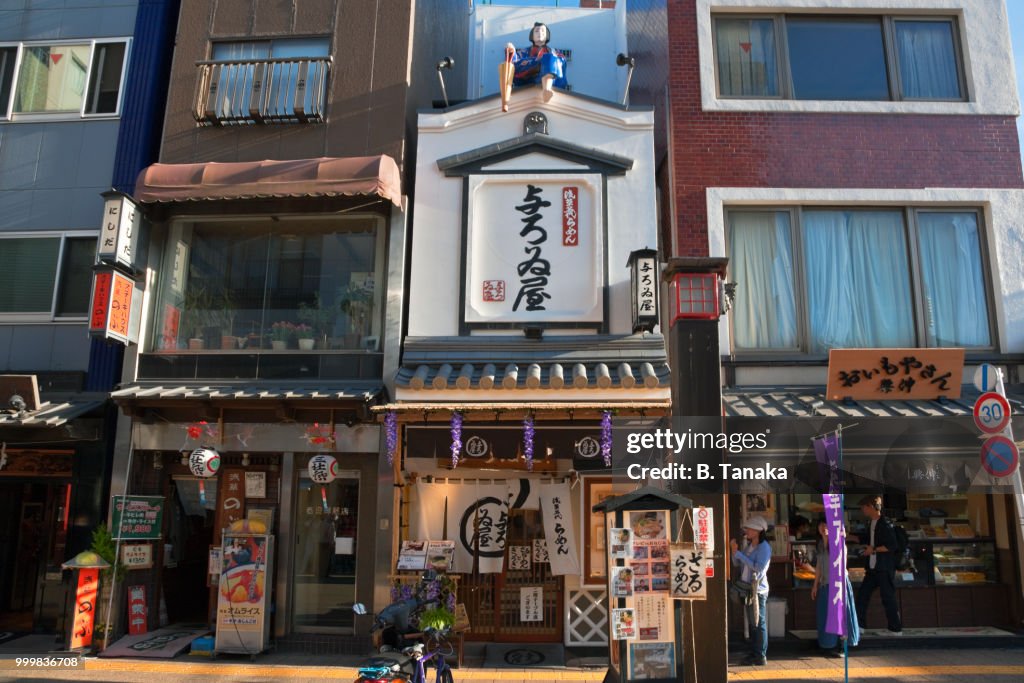 Edo Period Figure on Roof of Ramen Noodle Shop in the Old Downtown Asakusa District of Tokyo, Japan