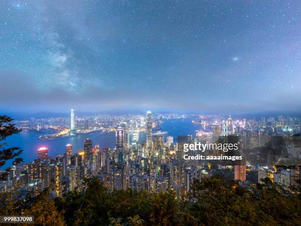 dramatic milky way over victoria harbor,hk - hk stock pictures, royalty-free photos & images