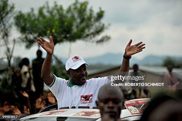 Burundian President Pierre Nkurunziza waves to supporters at the end of a political rally in the town of Rugombo in northern Burundi on May 14,...