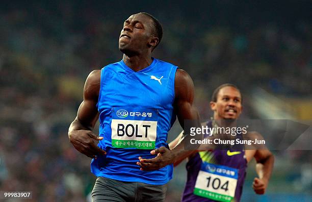 Usain Bolt of Jamaica celebrates after crossing the finish line of the men's 100 metres during the Colorful Daegu Pre-Championships Meeting 2010 at...
