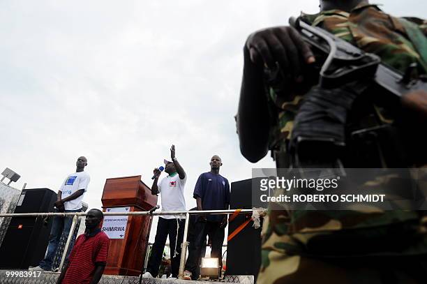 Burundian President Pierre Nkurunziza is surrounded by bodyguards during a political rally in the town of Rugombo in northern Burundi on May 14,...
