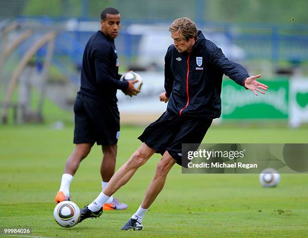 Peter Crouch shoots as Tom Huddlestone looks on during an England training session on May 19, 2010 in Irdning, Austria.