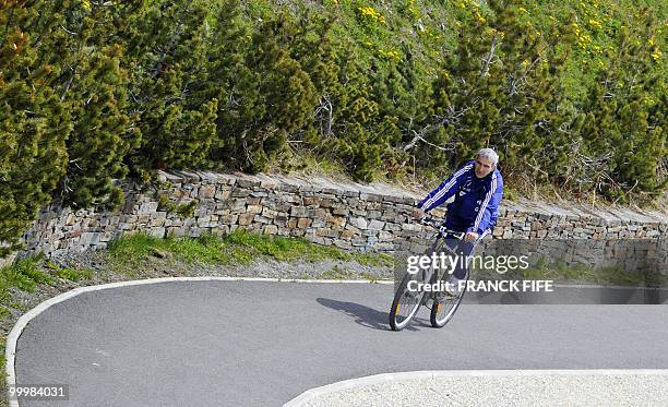 French football coach Raymond Domenech cycles during a training session around a lake, on May 19, 2010 in Tignes in the French Alps, as part of the...