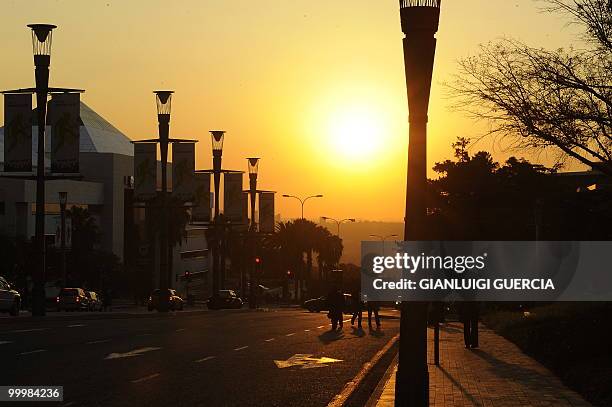 Johannesburg residents make their way home after work from Sandton city as the sun sets on May 18, 2010 in Johannesburg, South Africa. South Africa...