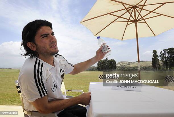 Germany's defender Serdar Tasci speaks to journalists during a so-called media day at the Verdura Golf and Spa resort, near Sciacca May 19, 2010. The...