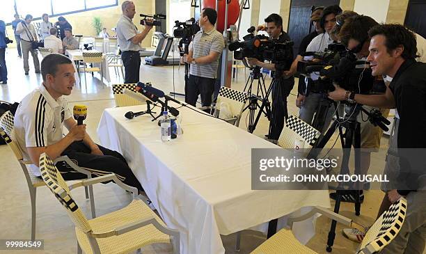 Germany's striker Lukas Podolski speaks to journalists during a so-called media day at the Verdura Golf and Spa resort, near Sciacca May 19, 2010....