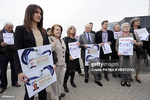 Journalists and European Parliament MPs including Sandrine Belier , Catherine Trautmann , Jean-Marie Cavada and Jose Bove hold posters featuring the...