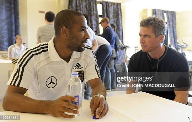 Germany's striker Cacau speaks to a journalist during a so-called media day at the Verdura Golf and Spa resort, near Sciacca May 19, 2010. The German...