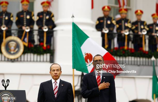 President Barack Obama and Mexican President Felipe Calderon stand for their countries' national anthems during a welcoming ceremony on the South...