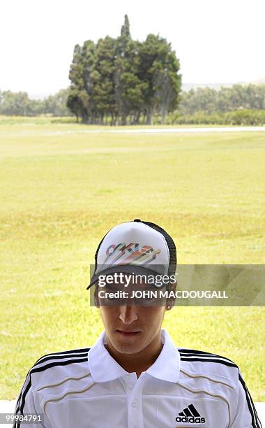 Germany's midfielder Mesut Oezil speaks to a journalist during a so-called media day at the Verdura Golf and Spa resort, near Sciacca May 19, 2010....