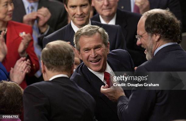 President George W. Bush smiles and greets Democrats after his State of the Union address.
