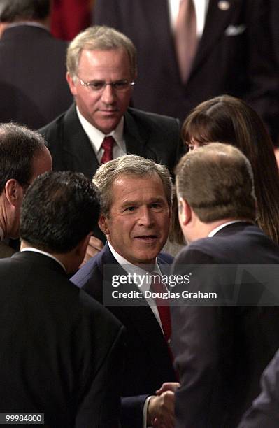 President George W. Bush smiles and greets Democrats after his State of the Union address.