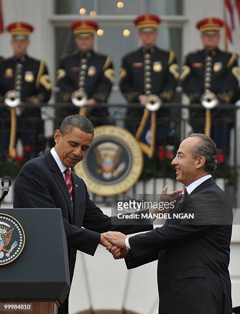 President Barack Obama and Mexico�s President Felipe Calderón shake hands May 19, 2010 during a welcome ceremony on the South Lawn of the White House...