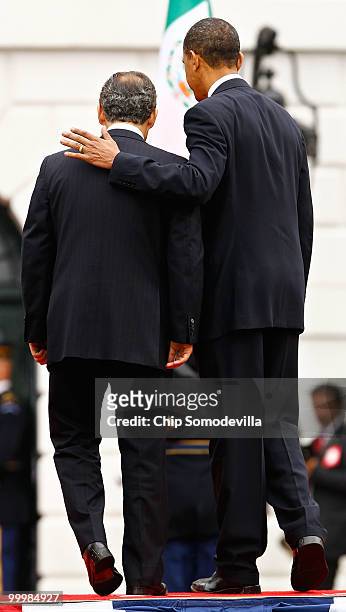 President Barack Obama puts his arm around Mexican President Felipe Calderon during a welcoming ceremony on the South Lawn of the White House May 19,...