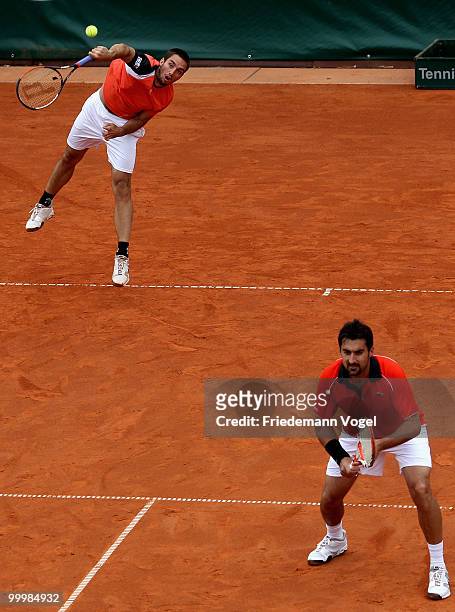 Viktor Troicki and Nenad Zimonjic of Serbia in action during their double match against Jeremy Chardy and Nicolas Mahut of France during day four of...