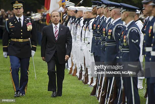 Mexico�s President Felipe Calderón inspects an honour guard May 19, 2010 during a welcome ceremony on the South Lawn of the White House to celebrate...