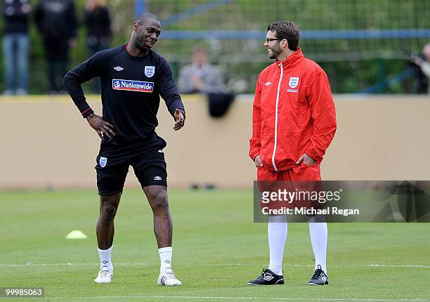 Ledley King shares a joke with a member of the backroom staff during an England training session on May 19, 2010 in Irdning, Austria.