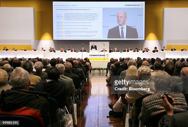 Martin Blessing, chief executive officer of Commerzbank AG, speaks on a large screen during the company's annual general shareholders' meeting in...