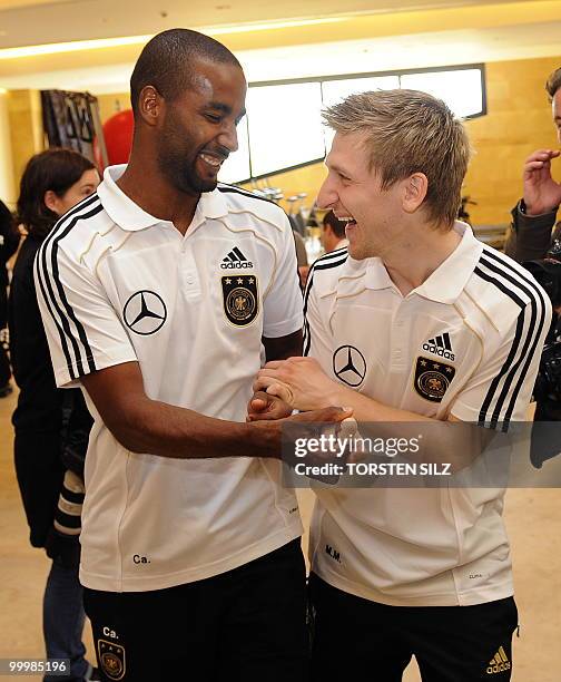 Germany's striker Cacau and midfielder Marko Marin joke during a so-called media day at the Verdura Golf and Spa resort, near Sciacca May 19, 2010....