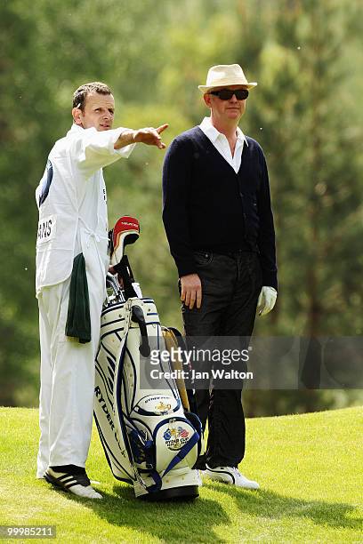 Presenter Chris Evans takes advice from his caddie during the Pro-Am round prior to the BMW PGA Championship on the West Course at Wentworth on May...