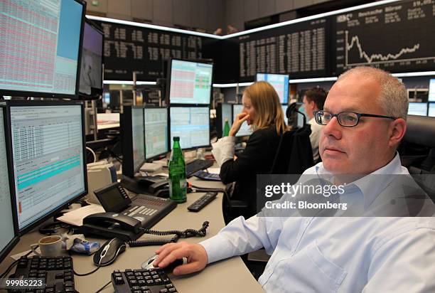 Trader Stefan Scharfetter works at the Frankfurt Stock Exchange in Frankfurt, Germany, on Wednesday, May 19, 2010. German stocks retreated after the...