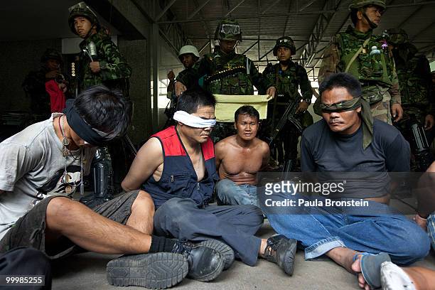 Red shirt anti-government protesters surrender to the military inside the red shirt camp on May 19, 2010 in Bangkok, Thailand. At least 5 people are...