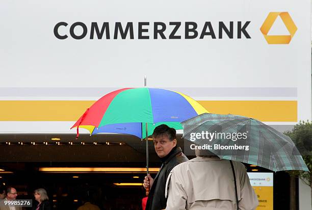 Shareholders arrive for the Commerzbank AG annual general shareholders' meeting in Frankfurt, Germany, on Wednesday, May 19, 2010. Commerzbank AG's...