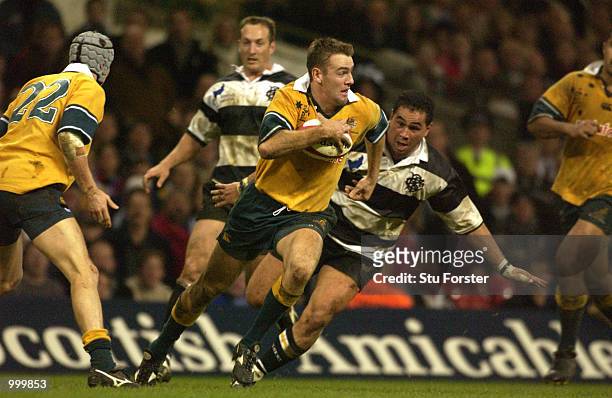 Chris Latham of Australia breaks away from Pat Lam of the Barbarians during the Scottish Amicable Challenge match between the Barbarians and...