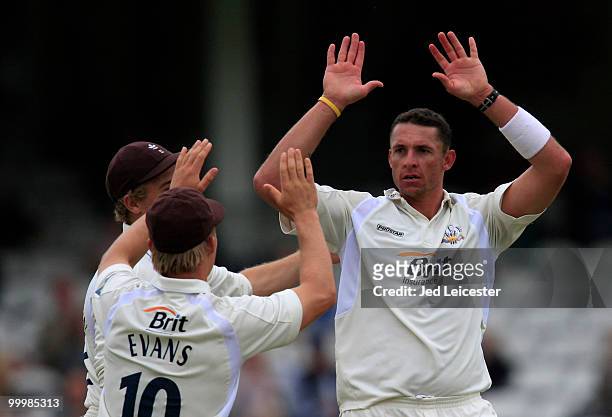 Surrey bowler Andre Nel celebrates with his team after helping to finish off the Middlesex innings for 324 by taking the wicket off Tim Murtagh...