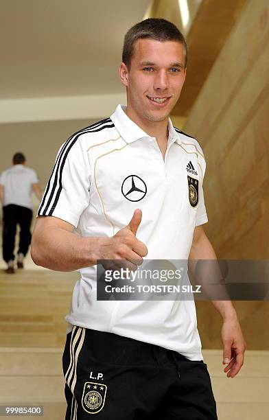 Germany's striker Lukas Podolski gives the thumbs up sign during a so-called media day at the Verdura Golf and Spa resort, near Sciacca May 19, 2010....